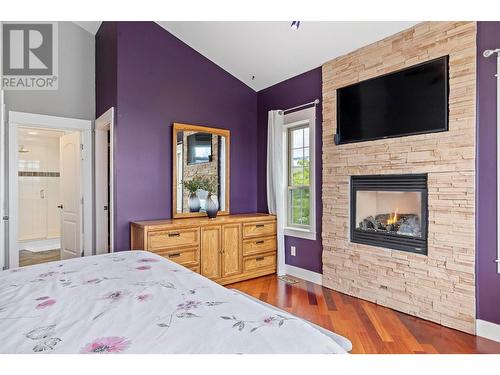 12852 Apex Drive, Lake Country, BC - Indoor Photo Showing Bedroom With Fireplace