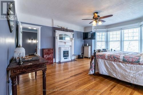 65 Albert Street N, Kawartha Lakes, ON - Indoor Photo Showing Bedroom With Fireplace