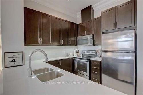 716-2480 Prince Michael Dr, Oakville, ON - Indoor Photo Showing Kitchen With Double Sink