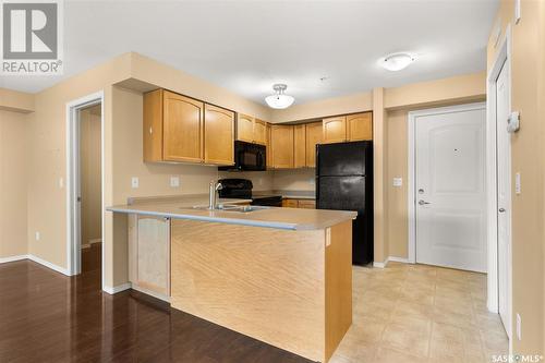 210 215 Smith Street N, Regina, SK - Indoor Photo Showing Kitchen With Double Sink