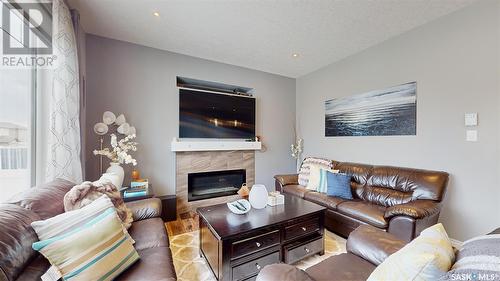 4314 E Green Olive Way, Regina, SK - Indoor Photo Showing Living Room With Fireplace