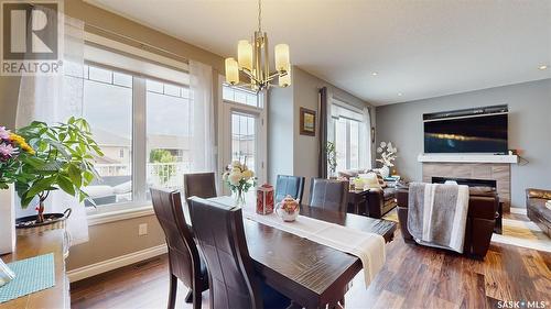 4314 E Green Olive Way, Regina, SK - Indoor Photo Showing Dining Room With Fireplace