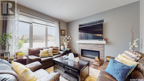 4314 E Green Olive Way, Regina, SK - Indoor Photo Showing Living Room With Fireplace