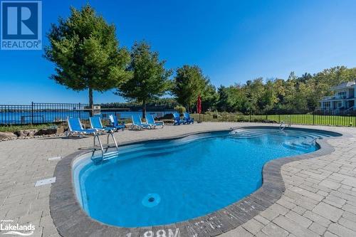 Pool & hot tub at the beach - 1869 Muskoka 118 Highway W Unit# L204-D1, Muskoka Lakes, ON - Outdoor With In Ground Pool With Backyard