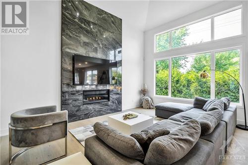 Floor to ceiling gas fireplace - 85 Chippewa Avenue, Ottawa, ON - Indoor Photo Showing Living Room