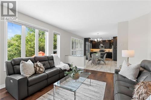 An open-concept family room that flows into the kitchen nook and chef's kitchen, perfect for enjoying family gatherings while the chef prepares a feast. - 2181 Des Grands Champs Way, Ottawa, ON - Indoor Photo Showing Living Room