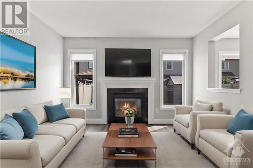 2651 Baynes Sound Way, Ottawa, ON - Indoor Photo Showing Living Room With Fireplace