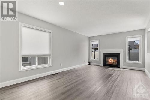 2651 Baynes Sound Way, Ottawa, ON - Indoor Photo Showing Living Room With Fireplace