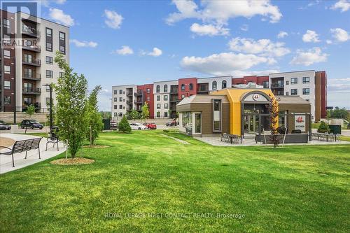 213 - 4 Spice Way, Barrie (Innis-Shore), ON - Outdoor With Balcony With Facade