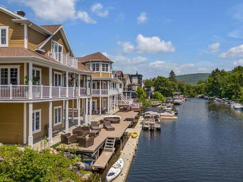 Backyard - 146 Av. De La Rivière, Fossambault-Sur-Le-Lac, QC - Outdoor With Body Of Water With Deck Patio Veranda