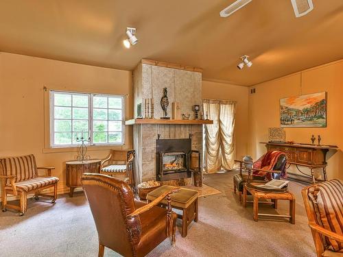 Family room - 136 Ch. De La Gare, Piedmont, QC - Indoor Photo Showing Living Room With Fireplace