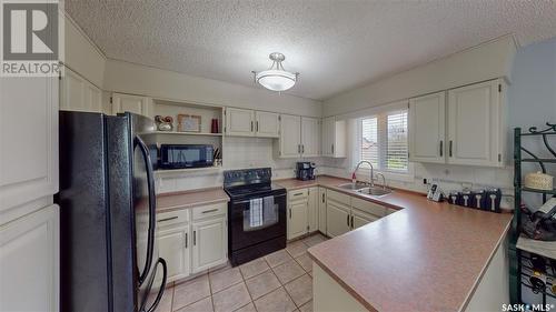 35 Meadow Road, White City, SK - Indoor Photo Showing Kitchen With Double Sink