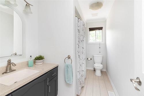 Main level bathroom, new vinyl flooring (2024). - 47 Simson Avenue, Simcoe, ON - Indoor Photo Showing Bathroom