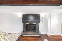 Lower level family room with tray ceiling, pot lights, surround sound and gas fireplace, freshly painted. - 