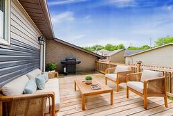 Virtually Staged. Oversized deck off the kitchen. - 