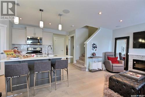 308 Myles Heidt Lane, Saskatoon, SK - Indoor Photo Showing Kitchen With Fireplace With Upgraded Kitchen