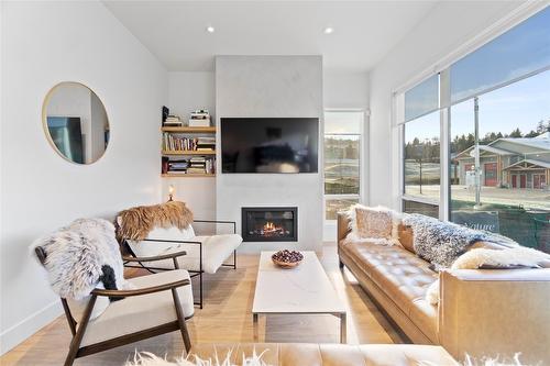 1-105 Predator Ridge Drive, Vernon, BC - Indoor Photo Showing Living Room With Fireplace