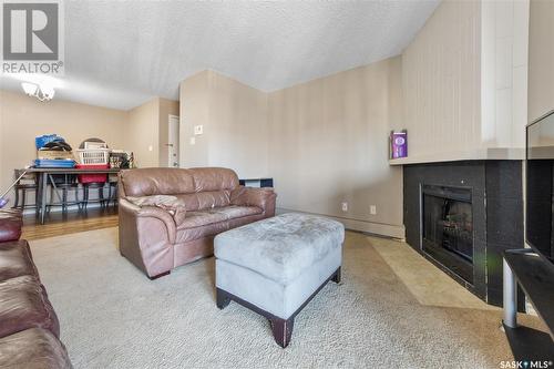 206D2 1121 Mckercher Drive, Saskatoon, SK - Indoor Photo Showing Living Room With Fireplace