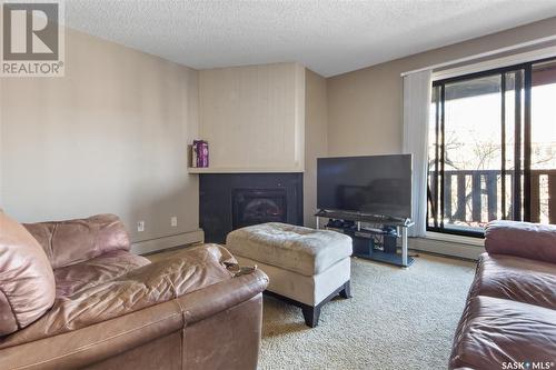 206D2 1121 Mckercher Drive, Saskatoon, SK - Indoor Photo Showing Living Room With Fireplace