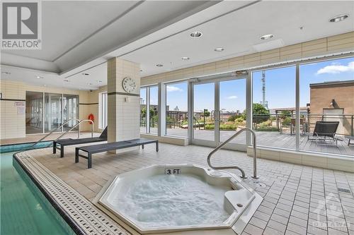 Whirlpool and swimming pool overlook the terrace.  There is also a sauna. - 90 George Street Unit#402, Ottawa, ON - Indoor Photo Showing Other Room With In Ground Pool