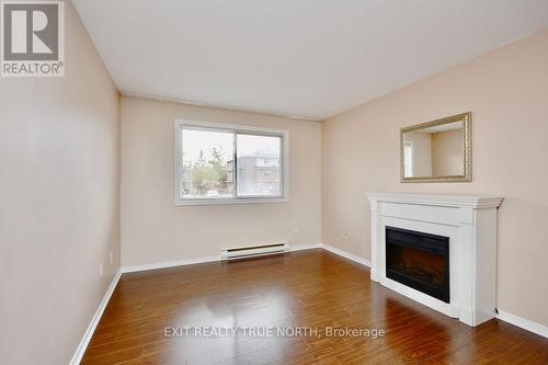 103 - 25 Meadow Lane, Barrie, ON - Indoor Photo Showing Living Room With Fireplace