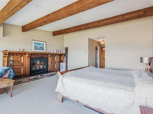 1141 Butterball Dr, Qualicum Beach, BC - Indoor Photo Showing Bedroom With Fireplace