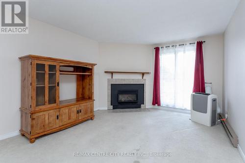 212 - 440 Wellington Street, St. Thomas, ON - Indoor Photo Showing Living Room With Fireplace