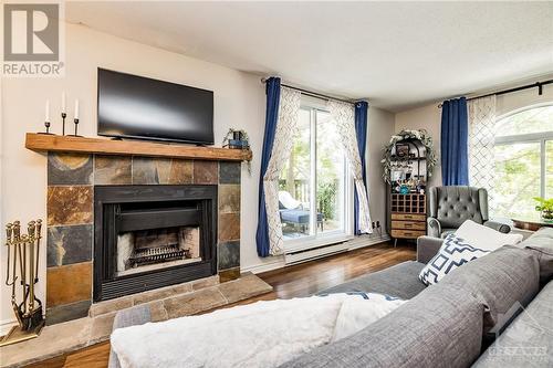 Cozy up to the wood burning fireplace on cold winter nights! - 616 Tanguay Court, Ottawa, ON - Indoor Photo Showing Living Room With Fireplace