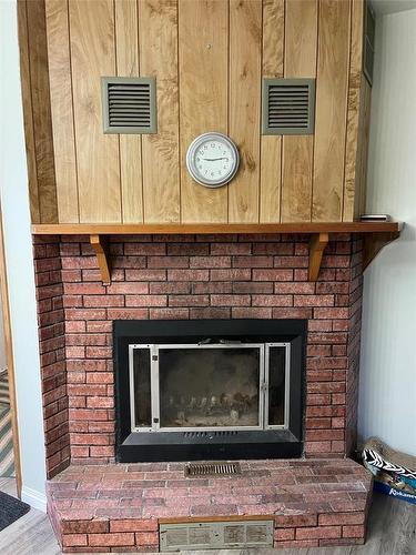 205 Athlone Street, Swan River, MB - Indoor Photo Showing Living Room With Fireplace