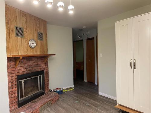 205 Athlone Street, Swan River, MB - Indoor Photo Showing Living Room With Fireplace