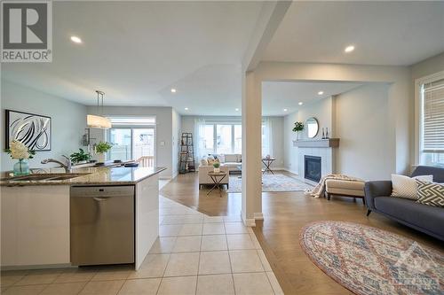 Open-concept design with a 9’ ceiling. - 348 Gloaming Crescent, Ottawa, ON - Indoor With Fireplace