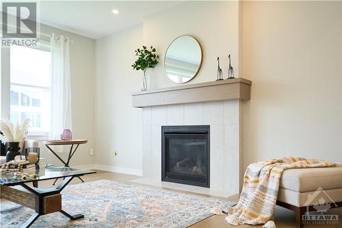 Expanded great room with a cozy gas fireplace & stunning windows. - 348 Gloaming Crescent, Ottawa, ON - Indoor Photo Showing Living Room With Fireplace