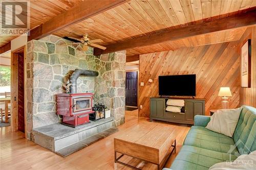 Wood stove head framed by a stone backdrop - 2589 Calabogie Road, Calabogie, ON - Indoor Photo Showing Living Room With Fireplace