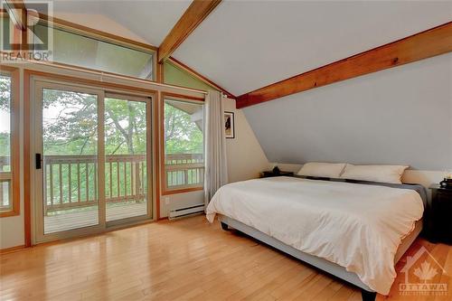 Sizeable primary bedroom drenched with light - 2589 Calabogie Road, Calabogie, ON - Indoor Photo Showing Bedroom