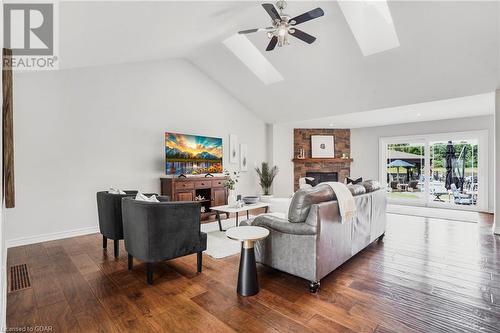 Spacious living room with vaulted ceilings, a cozy corner gas fireplace, and glass doors leading to an outdoor entertaining area. - 551 Darby Road, Welland, ON - Indoor Photo Showing Living Room With Fireplace