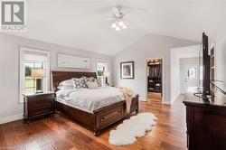 Principal Bedroom: Serene Retreat: Luxurious principal bedroom with designer walk-in closet, skylight, and private access to a covered hot tub deck for ultimate relaxation. - 