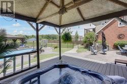 Private access from the Primary bedroom to the covered hot tub deck overlooking the backyard outdoor space. - 
