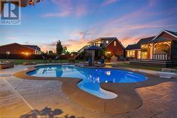The heated saltwater pool is accented with wrought iron fencing and non-slip decking. - 