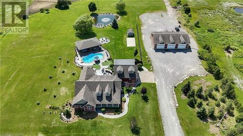 The property features an in-ground heated saltwater pool and a large covered cabana with a bar and entertainment facilities, creating a perfect backdrop for hosting gatherings or enjoying relaxed, pri - 551 Darby Road, Welland, ON - Outdoor With View