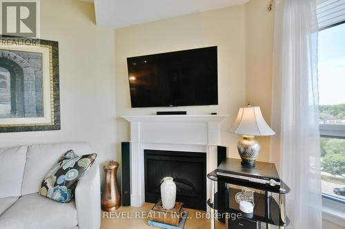 709 - 6 Toronto Street, Barrie, ON - Indoor Photo Showing Living Room With Fireplace