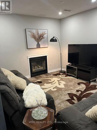 2 Country Lane, Barrie (Painswick South), ON - Indoor Photo Showing Living Room With Fireplace