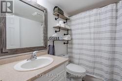 Bathroom in the lower level with custom shelves. - 