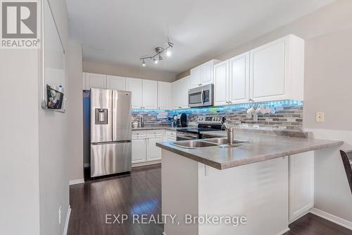 Kitchen with breakfast bar and removable lighting. - 22 Kristen Court, Middlesex Centre (Kilworth), ON - Indoor Photo Showing Kitchen With Double Sink