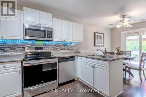 Leads out to rear deck via patio door. - 22 Kristen Court, Middlesex Centre (Kilworth), ON - Indoor Photo Showing Kitchen With Double Sink