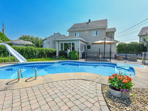 Back facade - 11 Rue Daubigny, Candiac, QC - Outdoor With In Ground Pool With Backyard