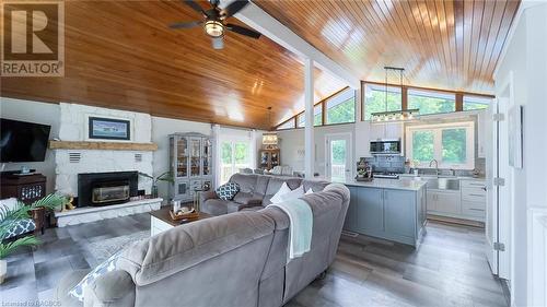 Open concept kitchen, dining, living room - 202 Birchwood Avenue, Kincardine Twp, ON - Indoor Photo Showing Living Room With Fireplace