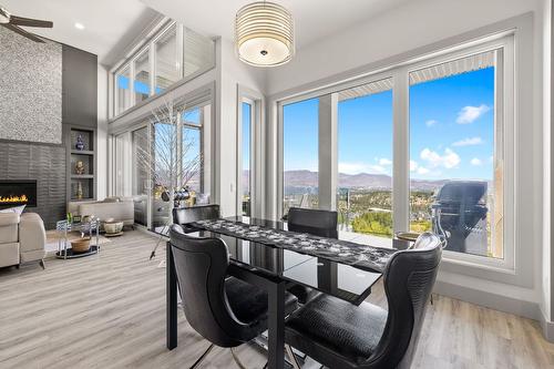 1290 Ponds Avenue, Kelowna, BC - Indoor Photo Showing Dining Room With Fireplace