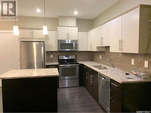 103 415 Maningas Bend, Saskatoon, SK - Indoor Photo Showing Kitchen With Stainless Steel Kitchen With Double Sink With Upgraded Kitchen