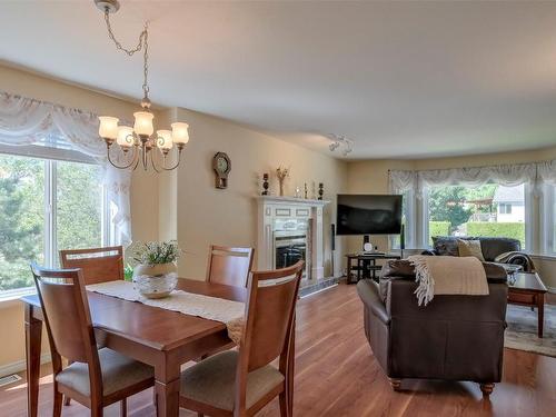 203 Biggar Road, Kelowna, BC - Indoor Photo Showing Dining Room With Fireplace