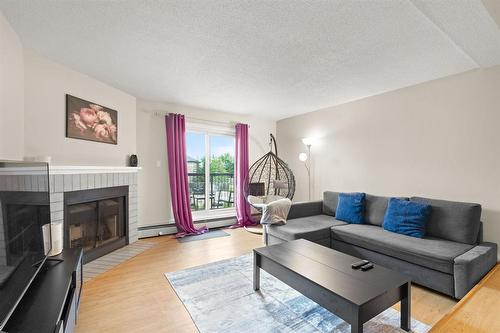 5216 173 Victor Lewis Drive, Winnipeg, MB - Indoor Photo Showing Living Room With Fireplace